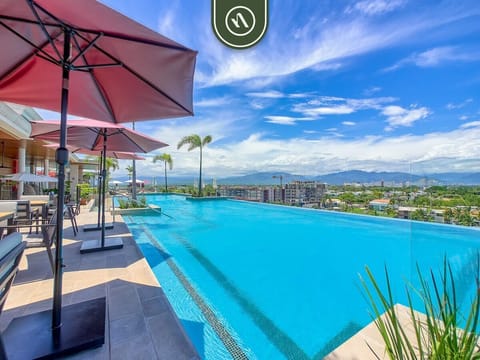Experience resort-style living with a stunning infinity pool, panoramic mountain views, elegant lounge areas, and premium amenities designed for comfort, relaxation, and luxury.