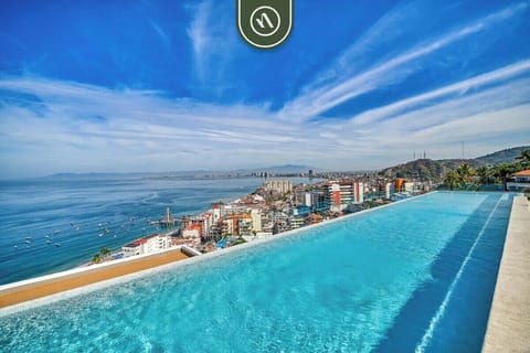 Spectacular rooftop infinity pool that blends seamlessly into the stunning panoramic ocean horizon and blue sky.