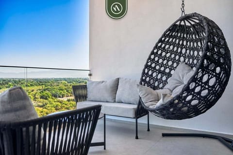 Unwind in a stylish hanging egg chair on your private balcony. This cozy nook offers breathtaking views of the lush greenery, providing the perfect spot for your morning coffee or sunset watching.