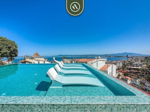 Stunning rooftop infinity pool with breathtaking ocean and city views, perfect for relaxing or enjoying sunset swims.