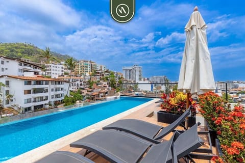 Relax on comfortable sun loungers by the stunning rooftop pool. Enjoy spectacular panoramic views of the charming town architecture and lush mountainsides while you soak up the beautiful weather.