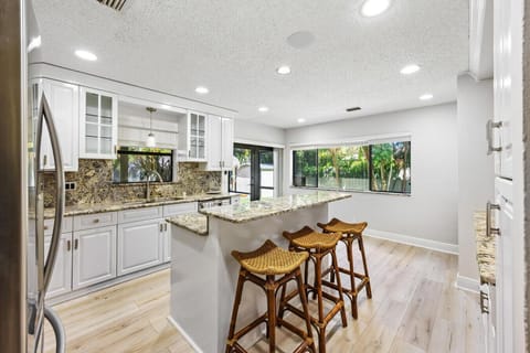 Stylish lounge space featuring comfortable blue chairs and lush outdoor scenery