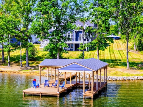 Waterfront View - The Shoreline sits on a quiet wooded lot with a private covered dock built right over the warm freshwater of Lake Anna.