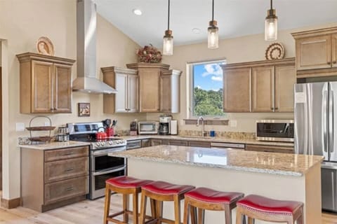 Cook and gather in this spacious open kitchen, complete with granite countertops, custom cabinetry, and seamless flow into the living area
