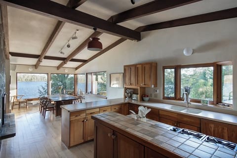 Cook with panoramic lake views in a fully stocked, design-forward kitchen.
