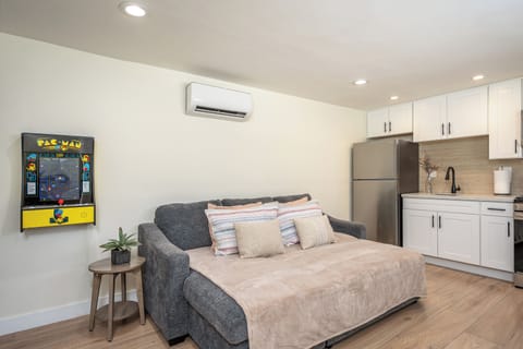 Cozy studio with sofa bed and Pac-Man arcade for fun nights