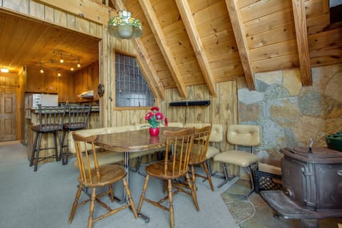 Gather around the dining table, which offers seating for four perfect for meals and game nights.