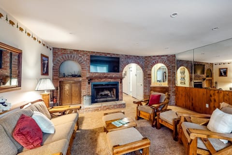 Bright living room with modern décor, cozy seating, and natural sunlight.