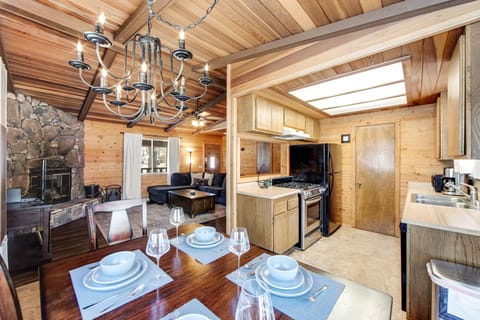 Elegant dining room with wooden table, soft lighting, and modern chairs.