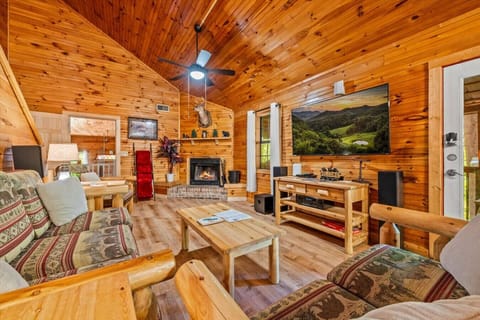 A large Smart TV, comfortable furniture and a warm fireplace offer the perfect space to enjoy your Smoky Mountain getaway.