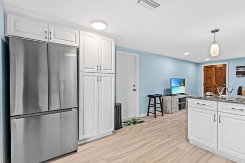 Spacious kitchen with a French-door fridge and plenty of storage for groceries, drinks, and beach snacks.