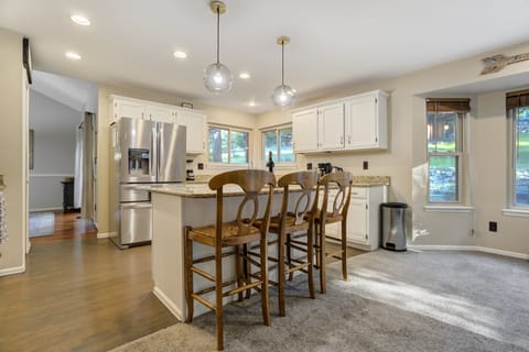 Kitchen island with three barstools — perfect for casual meals or morning coffee.