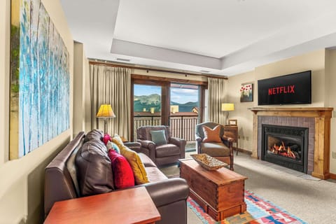 Comfortable living area with gas fireplace, balcony and amazing views | Listed with @BookTraverse