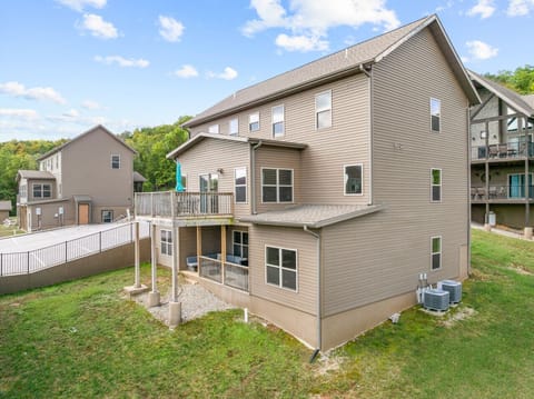 A wide look at the lake side of the cabin, highlighting the decks and open space.