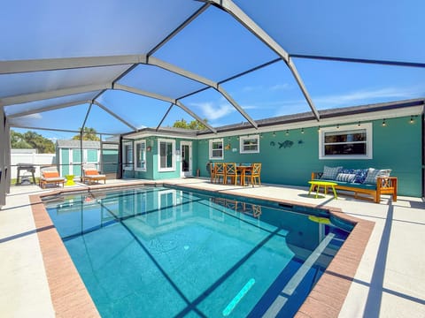 Fully screened-in private 26x14 HEATED pool with a fully fenced-in yard