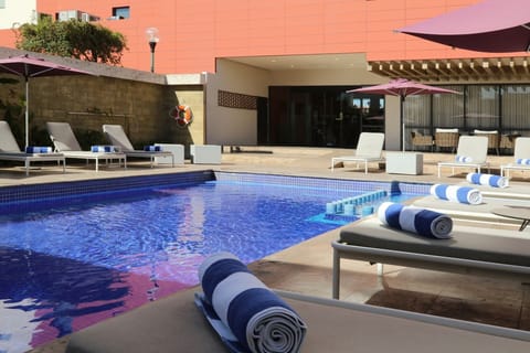 Stretch out poolside with fresh towels and shaded loungers.