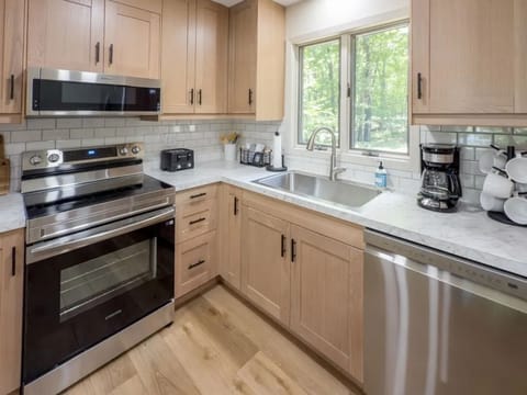 The modern kitchen combines functionality with style, featuring sleek cabinetry and ample counter space for cooking adventures.