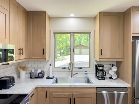 The kitchen features modern cabinetry and a cozy view of the outdoors, making it a welcoming space for meal preparation.