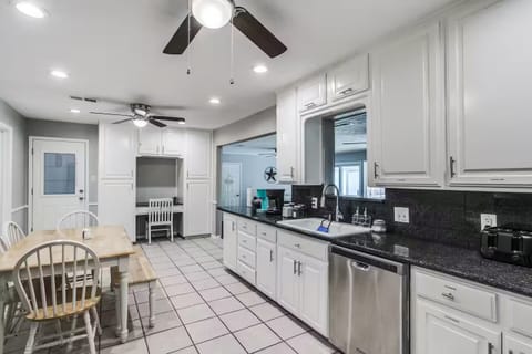 Eat-in kitchen with workstation, open to living room.