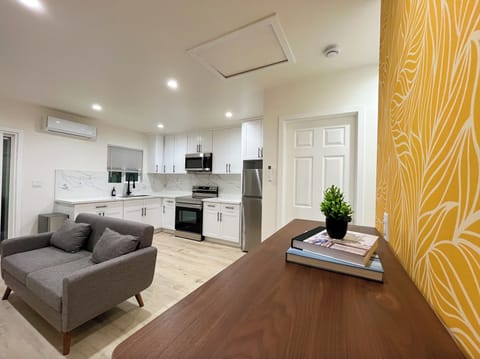 Entry area with view of living area, dining area, and kitchen.