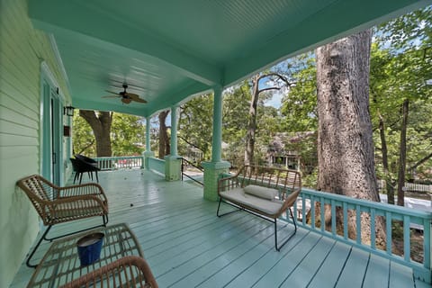 Spacious wraparound porch surrounded by trees, perfect for morning coffee or quiet afternoons