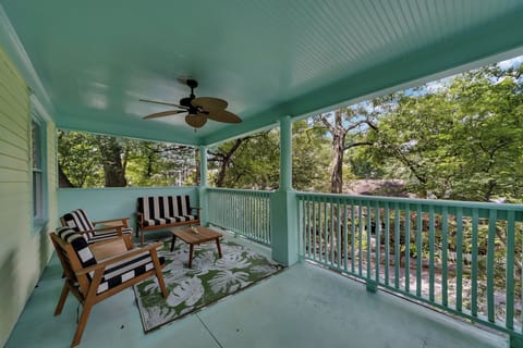 Covered porch w/ seating, ceiling fan & peaceful tree-lined surroundings