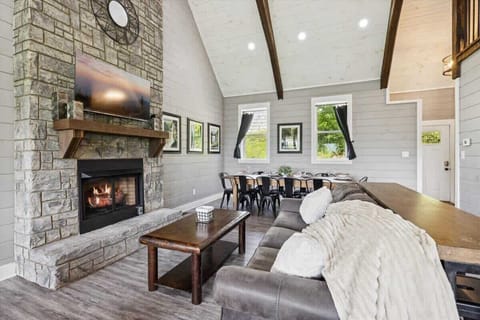 Stylish space with a stone fireplace, inviting views, and gathering-friendly decor!