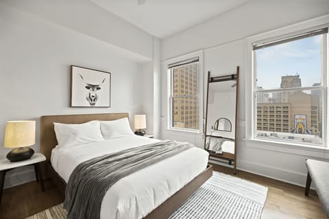 Wake refreshed beside large windows and cozy bedside lighting.