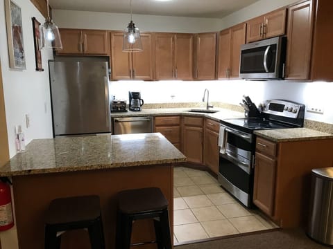 Right side - Well-organized Stainless Steel & Granite kitchen.  If you like to cook, you are in the right place we have all of the pot`s, pans, baking sheet, muffin tins, cake pans, roasting pans you`ll need.  We also have loads of dry spices too.