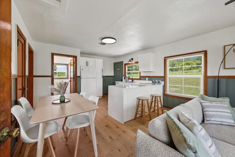 Stylish, sunlit kitchen and dining space with modern touches and cozy charm.