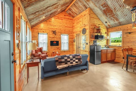 View looking left from the entry door showing the living room and kitchentte.