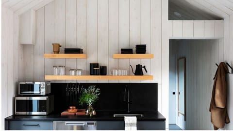 Cook easy meals in the sleek kitchenette with open shelving
