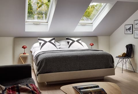 Recharge beneath skylights in a plush bed made for sleep.