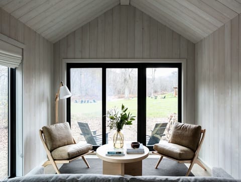 Sip morning coffee by expansive doors overlooking peaceful grounds.