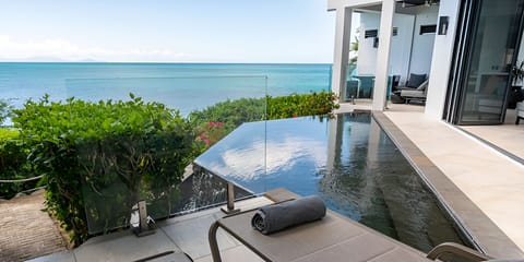 Soak in sunlit serenity beside the glass-edged infinity pool.