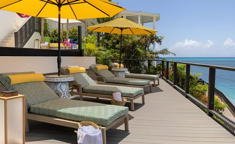 Stretch out on sun loungers with endless ocean views.