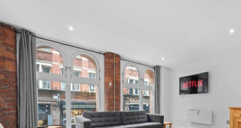 Stylish open plan living with warm wooden floors and plenty of space to unwind