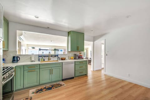 Fully stocked with utensils and cooking supplies, stainless steel appliances