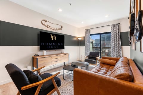 Unwind in the spacious living room, where cozy seating, warm décor, and plenty of natural light create the perfect atmosphere for relaxation and conversation.