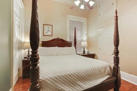 Drift off in crisp linens under soft lighting and tall ceilings.