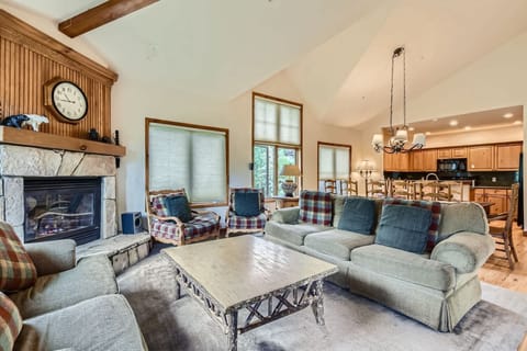 Living room with gas fireplace, cozy seating, and balcony access
