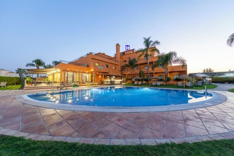 Seasonal outdoor pool, open 9:00 AM to 8:00 PM, pool umbrellas