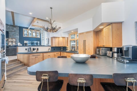 Your gourmet kitchen features a spacious island with seating, modern appliances, and an open design perfect for cooking and gathering with family.