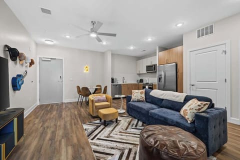 - Bright living room with open layout and modern decor perfect for relaxing stays  
- Cozy seating stylish accents and smart TV for unwinding nights  
- Wood flooring and spacious design ideal for extended visits  
