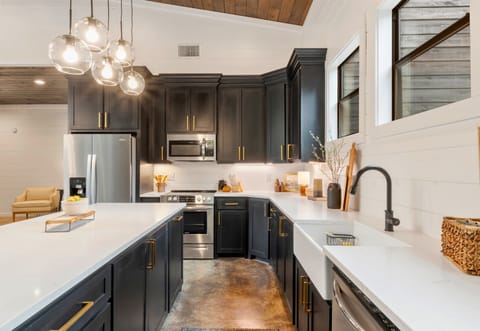 Meal prep is a breeze in a kitchen that blends functionality with elegance, boasting state-of-the-art appliances and expansive countertops.