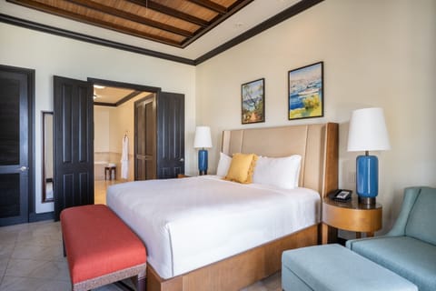 Unwind in crisp linens with warm wood ceiling details.