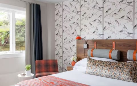 Sink into plush bedding in a bright, designer-styled room.