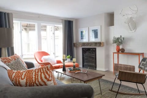 Unwind by the fireplace on plush, designer seating.