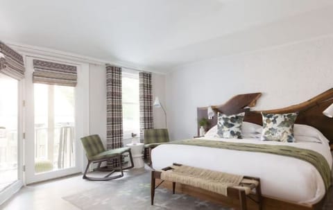 Drift off in a tranquil room with sculptural wood headboard.