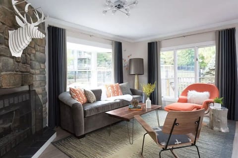 Gather for cozy evenings by the fireplace in sunlit comfort.
